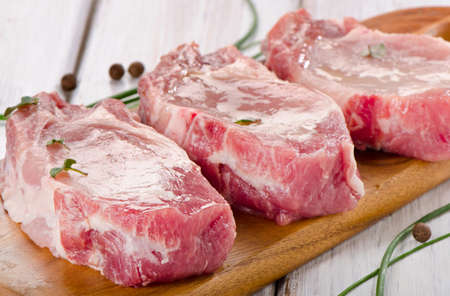 pork steaks on a wooden board. Selective focusの写真素材