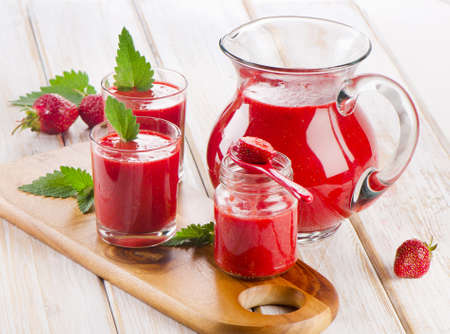 Strawberry smoothie with fresh berries on a wooden table . Selective focusの写真素材
