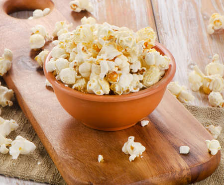 Popcorn in  bowl on a wooden table. Selective focusの写真素材
