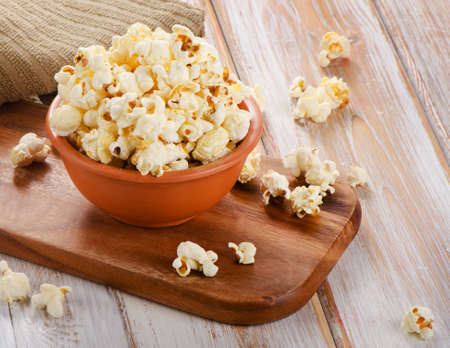 Popcorn in  bowl on a wooden table. Selective focusの写真素材