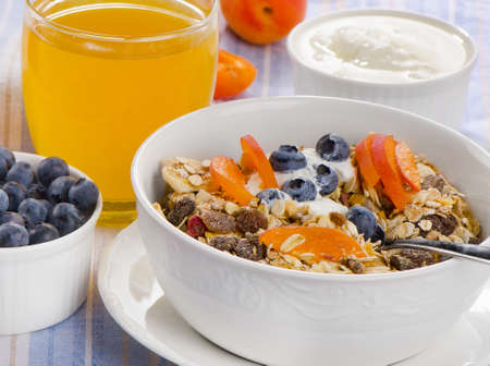 Healthy breakfast - muesli with yogurt and fresh juice . Selective focusの写真素材