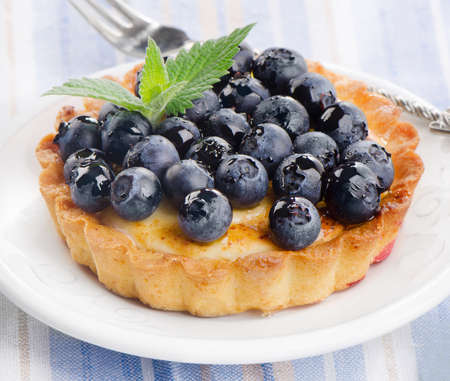 Fresh Blueberry tart on a white plate. Selective focusの写真素材