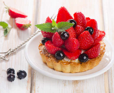 Fresh berries tart on a white plate. Selective focusの写真素材