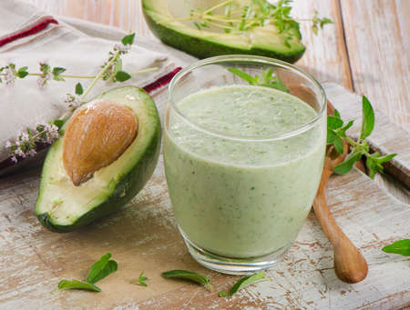 Avocado smoothie on a wooden table. Selective focusの写真素材
