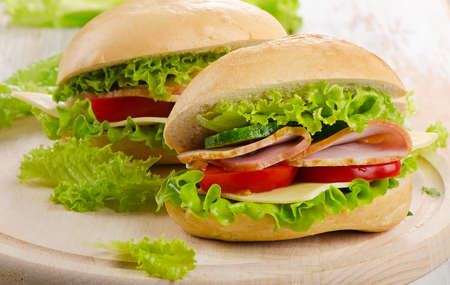 Fresh sandwich  on a wooden cutting board. Selective focusの写真素材