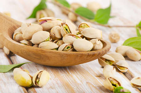 Pistachios in a wooden spoon. Selective focusの写真素材