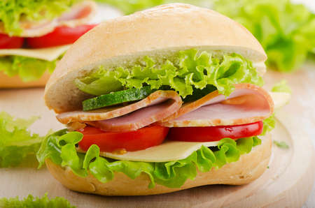 Fresh sandwich  on a wooden cutting board. Selective focusの写真素材