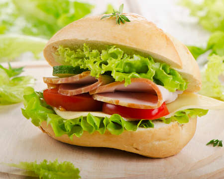 Fresh sandwich  on a wooden cutting board. Selective focusの写真素材