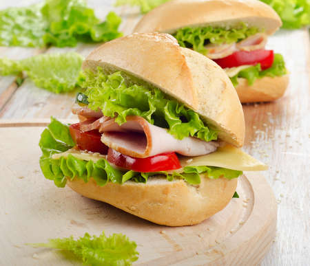 Fresh sandwich  on a wooden cutting board. Selective focusの写真素材