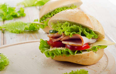 Fresh sandwich  on a wooden cutting board. Selective focusの写真素材
