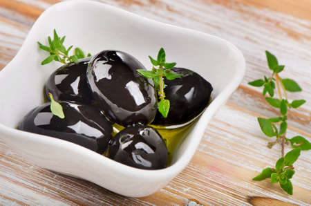 Black Olives  with fresh herbs. Selective focusの写真素材