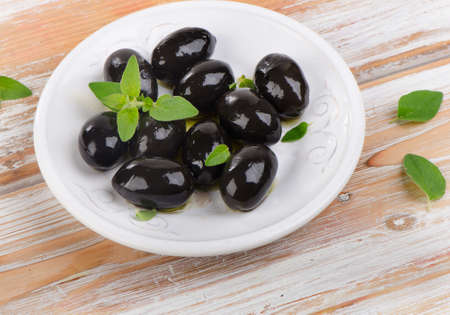 Olives  on a wooden table. Selective focusの写真素材
