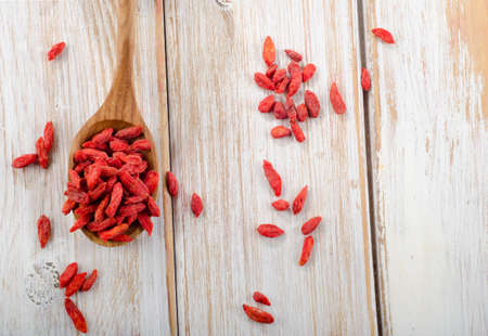 Red goji berries on a wooden table   