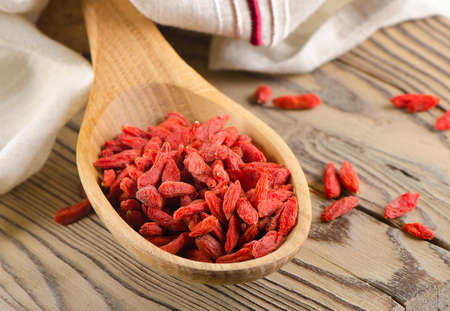 Red goji berries on wooden table  Selective focusの写真素材