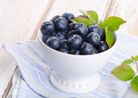 Fresh blueberries in a white bowl. Selective focusの写真素材
