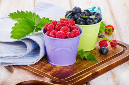Fresh berries on a wooden board . selective focusの写真素材