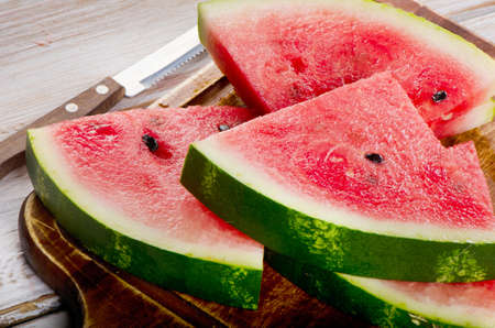 slices of watermelon on wooden table. selective focusの写真素材