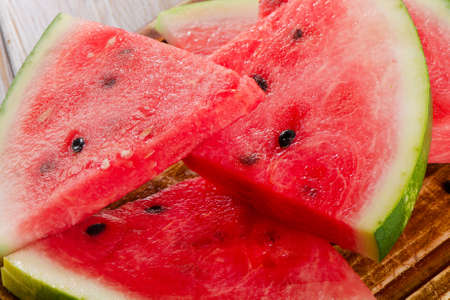 slices of watermelon on wooden table. selective focusの写真素材