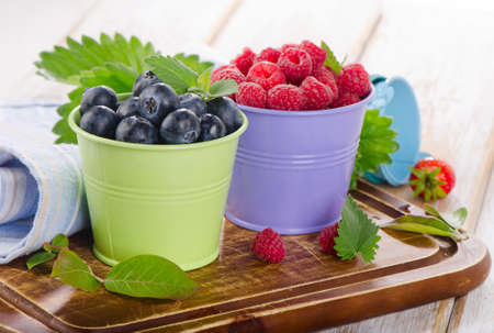 Fresh berries on a wooden board . selective focusの写真素材