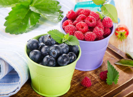 Fresh berries on a wooden board . selective focusの写真素材