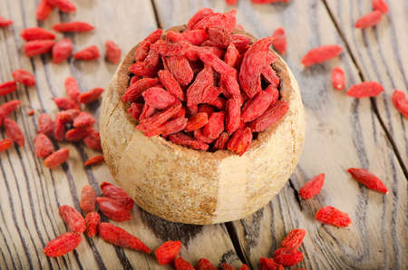 Red goji berries on wooden table. Selective focusの写真素材