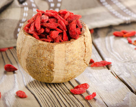 Red goji berries on wooden table. Selective focusの写真素材