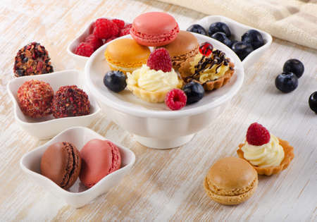 Sweet dessert - Colorful macaroons and cupcakes . Selective focusの写真素材