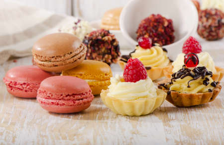 Sweet dessert - Colorful macaroons and cupcakes . Selective focus