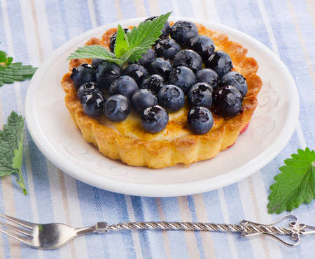 Blueberry tart on a white plate. Selective focusの写真素材
