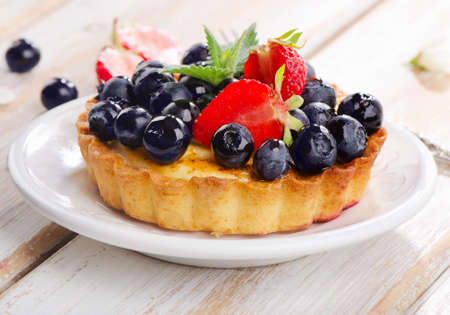 Fresh berry tart on a white plate. Selective focusの写真素材