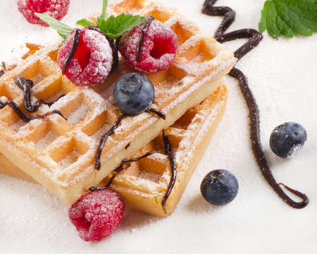 Belgian waffles with blueberries and raspberries. Selective focusの写真素材