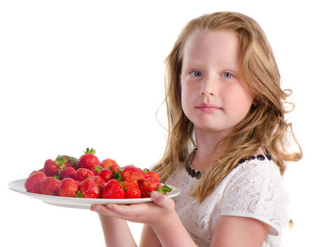 Cute little girl with  strawberry isolated on  a white backgroundの写真素材