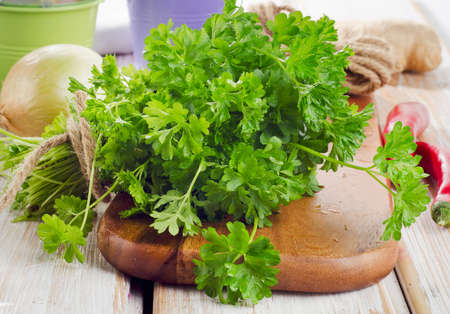 Fresh parsley on a wooden table. Selective focusの写真素材