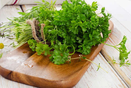 Fresh parsley on a wooden table. Selective focusの写真素材