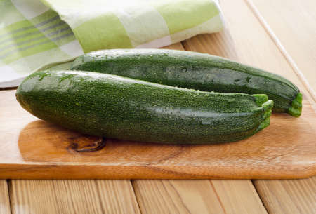 Fresh zucchini on a wooden  cutting board. Selective focusの写真素材