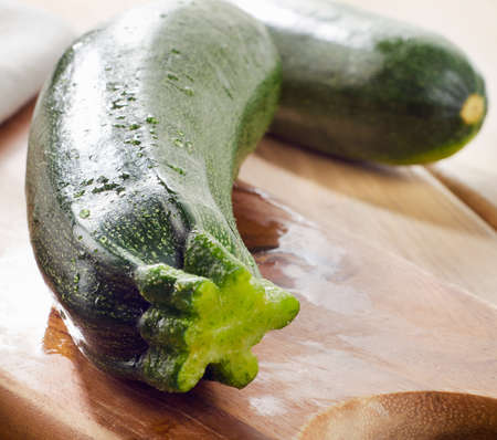 Fresh zucchini on a wooden  cutting board. Selective focusの写真素材