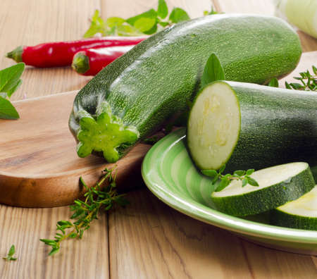 Fresh green zucchini  with herbs. Selective focusの写真素材