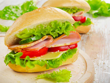 Fresh sandwich  on a wooden cutting board. Selective focusの写真素材