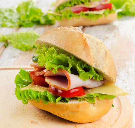 Fresh sandwich  on a wooden cutting board. Selective focusの写真素材
