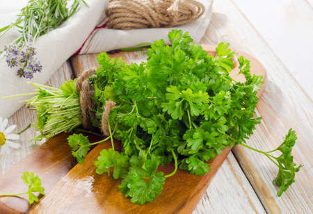 Fresh parsley on a wooden table. Selective focusの写真素材