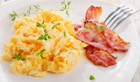 Breakfast - Scrambled eggs and bacon . Selective focusの写真素材