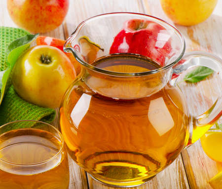 Apple juice and apples on wooden table. Selective focusの写真素材