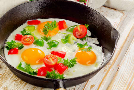 Fried eggs in  pan with vegetables. Selective focusの写真素材