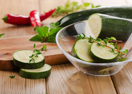 Fresh zucchini on a wooden  cutting board. Selective focusの写真素材