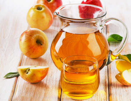 Apple juice and apples on wooden table. Selective focusの写真素材