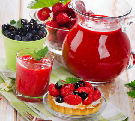 sweet cake and fresh berries on a wooden table . Selective focusの写真素材