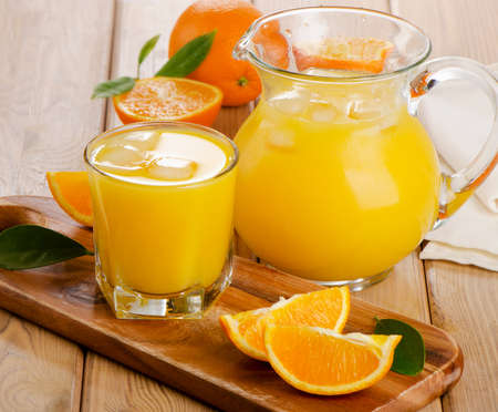 Glass and jug of  orange juice with sliced orange. Selective focusの写真素材