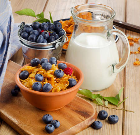 Healthy breakfast - Corn flakes with fresh blueberries and milk  Selective focus