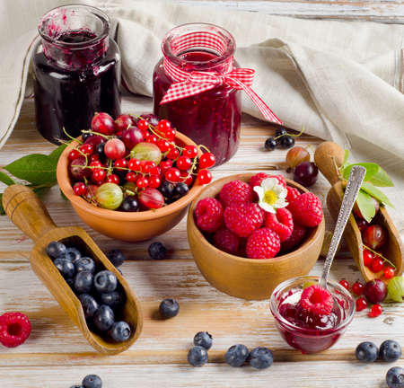 Fresh berries and jam on a wooden table  Selective focusの写真素材