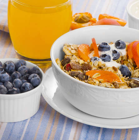 Healthy breakfast - muesli with yogurt and fresh juice   Selective focusの写真素材